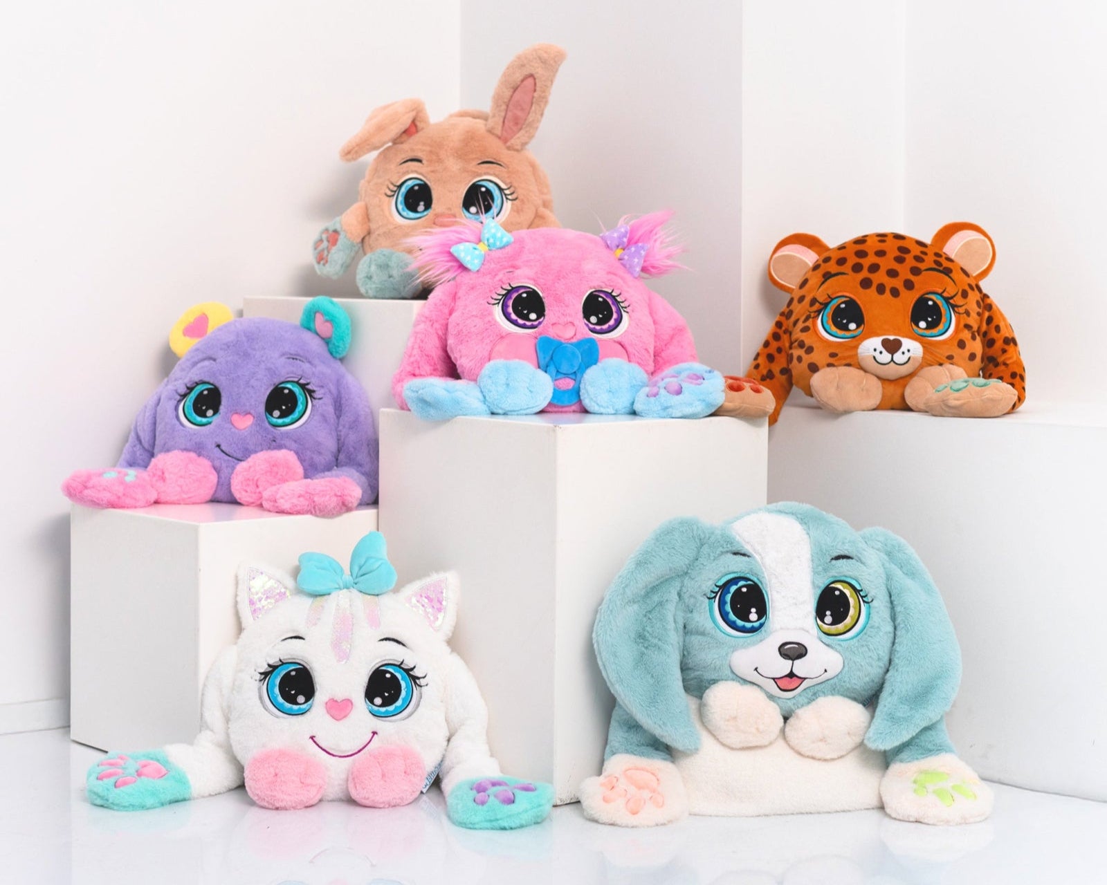 Set of colorful plush toys with large eyes on a white background