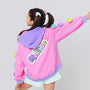 A girl wearing a cool colorful hoodie with rainbow 3D hearts plush accessories attached on sleeves