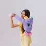 Girls holding a purple plush weighted toy featuring 3D sensory cheeks, paws, and nose, with pink paws, blue accents, and large expressive eyes. This soft, cuddly sensory plush is perfect for relaxation, stress relief, and comfort, shown on a clean white background.