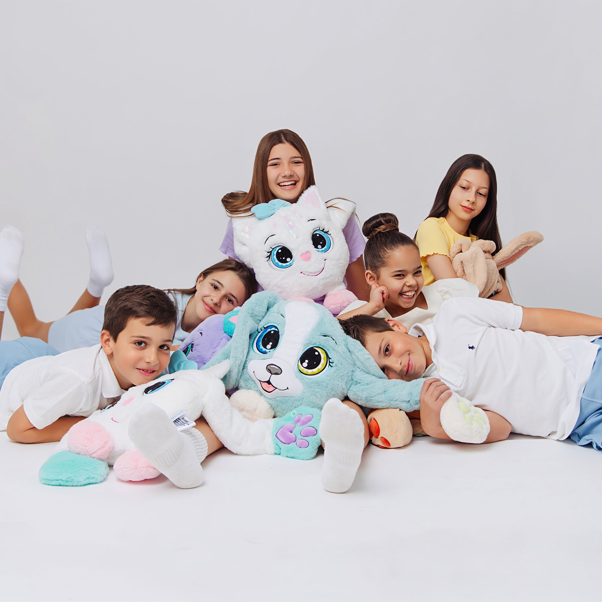 Children having fun with weighted plush toys, each featuring large expressive eyes, 3D sensory cheeks, paws, and nose. These ultra-soft, cuddly sensory plushies provide comfort, relaxation, and stress relief, beautifully displayed on a white background.