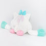Pastel-colored plush toy with a bow on a white background