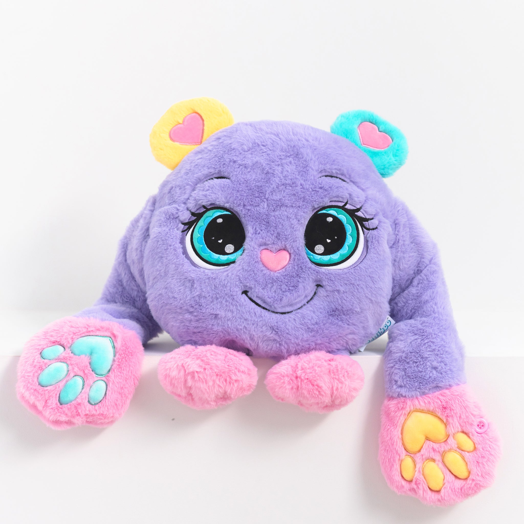 Purple plush weighted toy featuring 3D sensory cheeks, paws, and nose, with pink paws, blue accents, and large expressive eyes. This soft, cuddly sensory plush is perfect for relaxation, stress relief, and comfort, displayed on a clean white background.